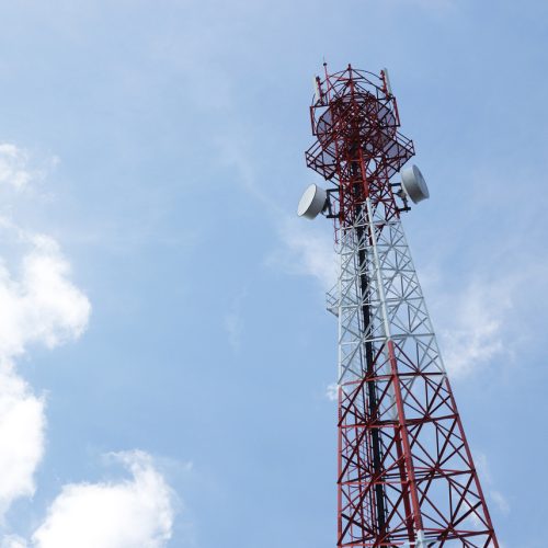 Telecommunications antenna for radio, television and telephone with cloud and blue sky